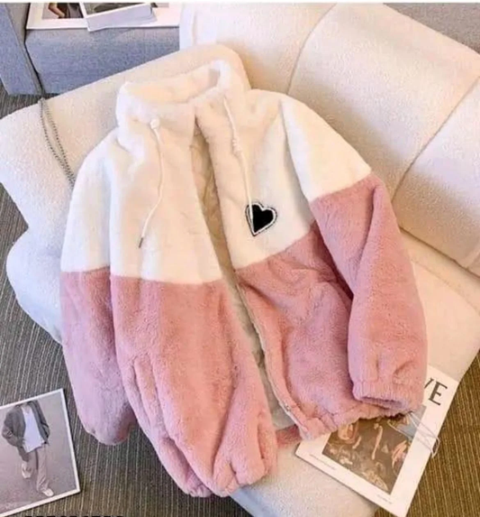 Fluffy pink and white blanket with a heart design.